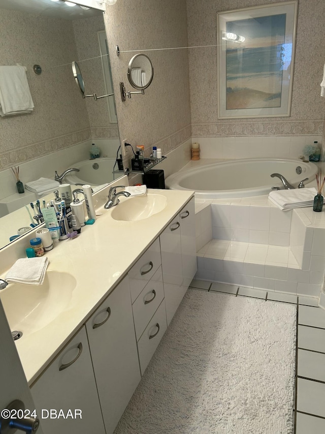 bathroom featuring vanity, a relaxing tiled tub, and tile patterned floors