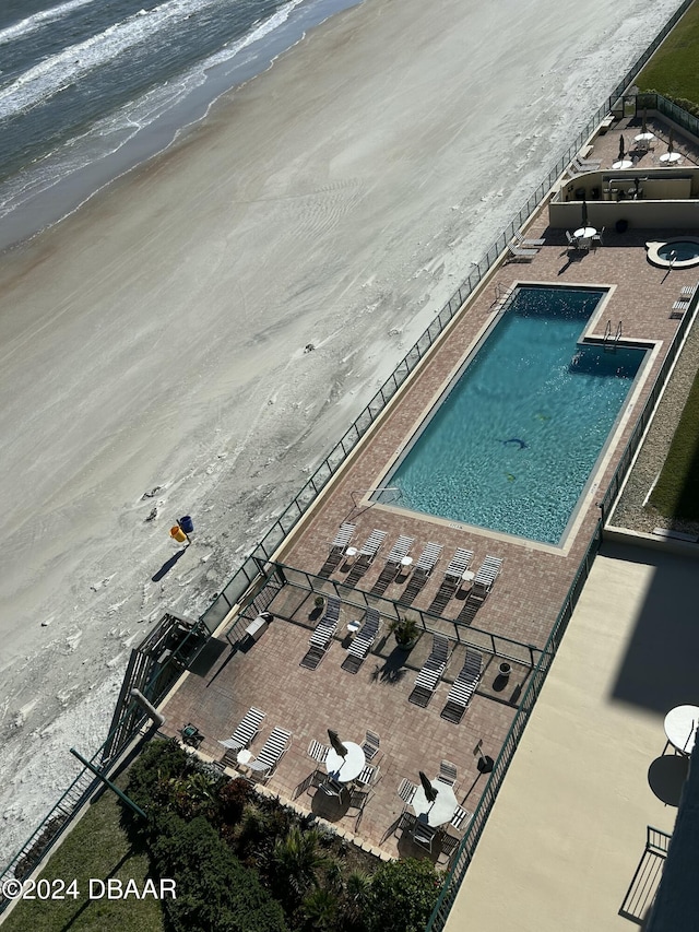 aerial view featuring a water view and a view of the beach