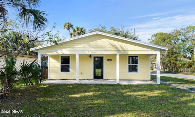 bungalow-style home featuring a front lawn and covered porch