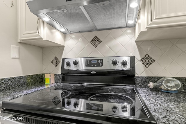 kitchen featuring dark stone counters, backsplash, extractor fan, and stainless steel electric range