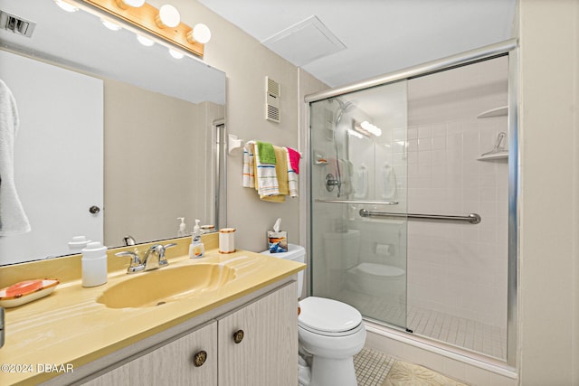 bathroom with tile patterned floors, vanity, toilet, and walk in shower