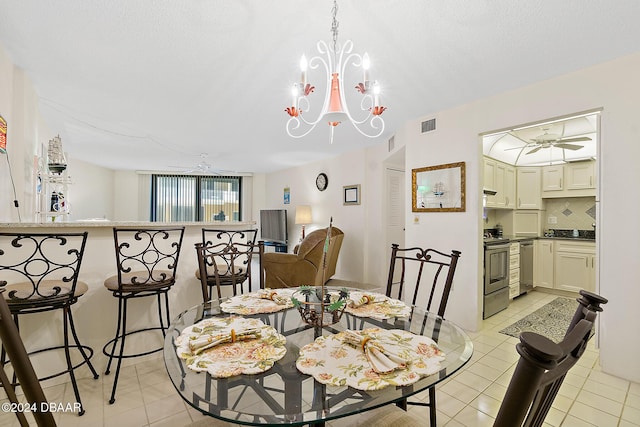 tiled dining room featuring ceiling fan with notable chandelier