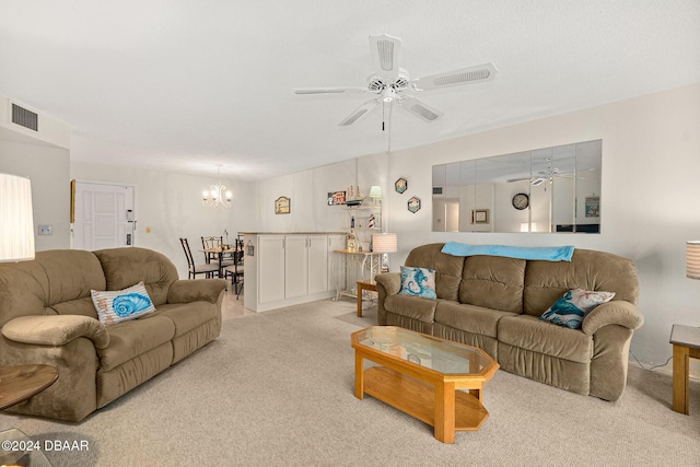 living room with ceiling fan with notable chandelier and light colored carpet