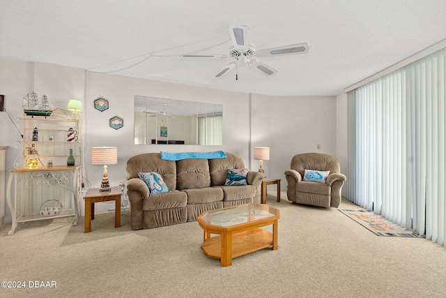 living room with carpet, a textured ceiling, and ceiling fan