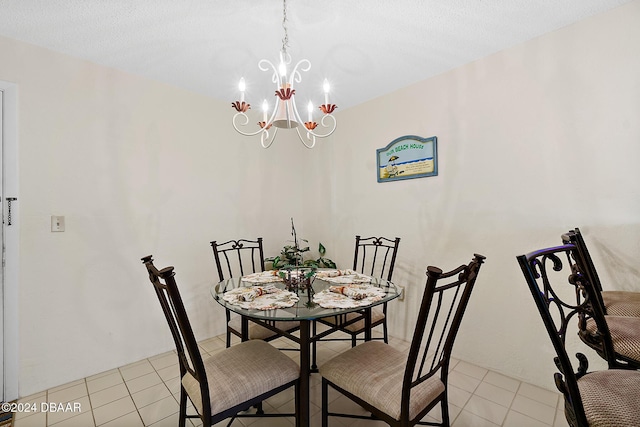 dining room featuring light tile patterned floors, a textured ceiling, and a chandelier