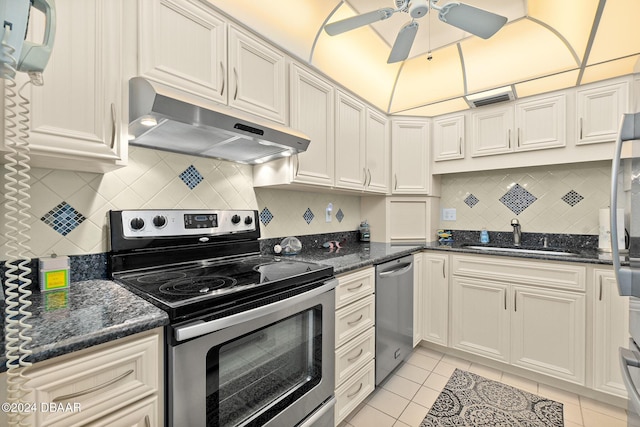 kitchen featuring decorative backsplash, light tile patterned floors, stainless steel appliances, and sink