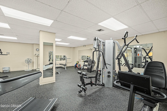 exercise room featuring a paneled ceiling