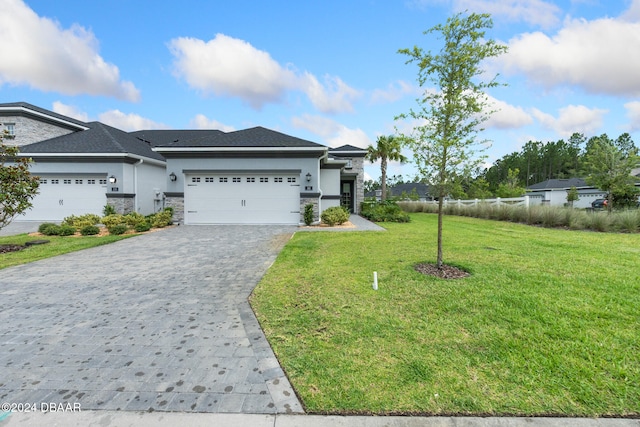 view of front of home featuring a front yard and a garage