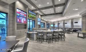 interior space with beamed ceiling, light wood-type flooring, and coffered ceiling