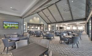 carpeted dining area with high vaulted ceiling