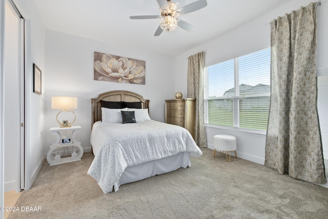 bedroom with light carpet and ceiling fan