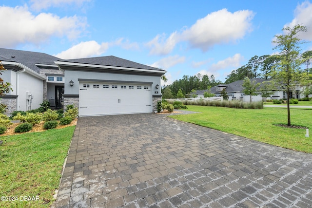 view of front of home featuring a front lawn and a garage