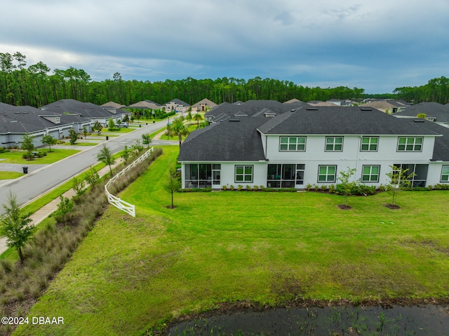 back of property featuring a lawn