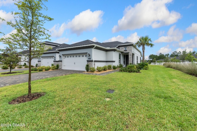 view of front facade featuring a front yard and a garage