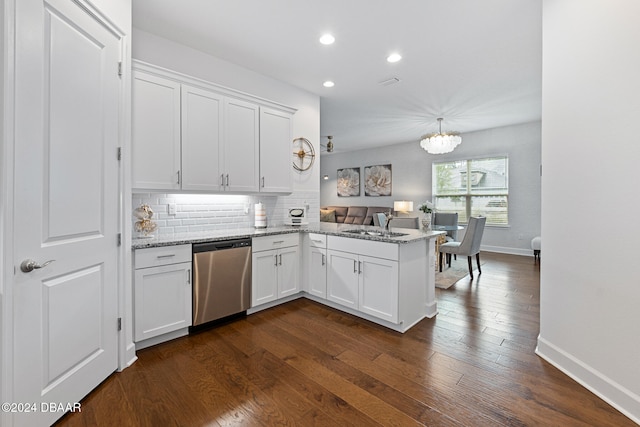 kitchen featuring kitchen peninsula, dark hardwood / wood-style flooring, white cabinetry, and stainless steel dishwasher