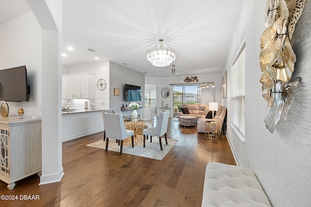 dining space featuring a notable chandelier and dark hardwood / wood-style floors