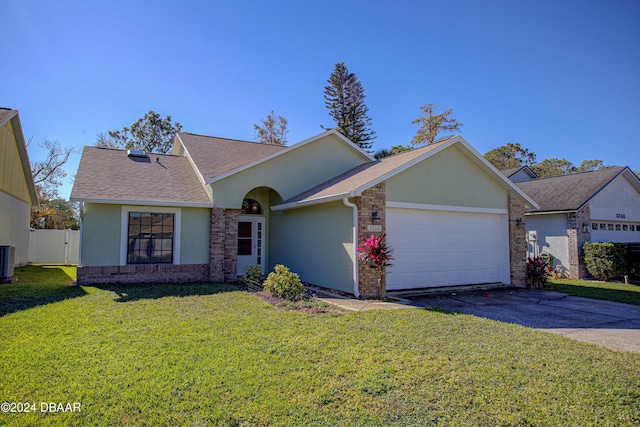 ranch-style home featuring a garage, central air condition unit, and a front yard