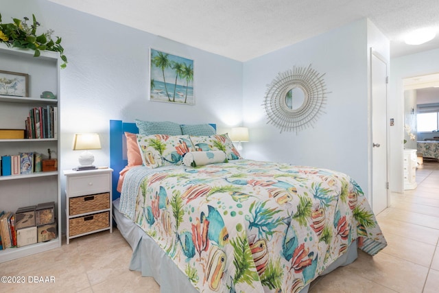 tiled bedroom featuring a textured ceiling