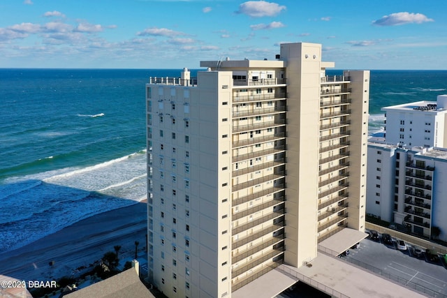 view of property with a view of the beach and a water view