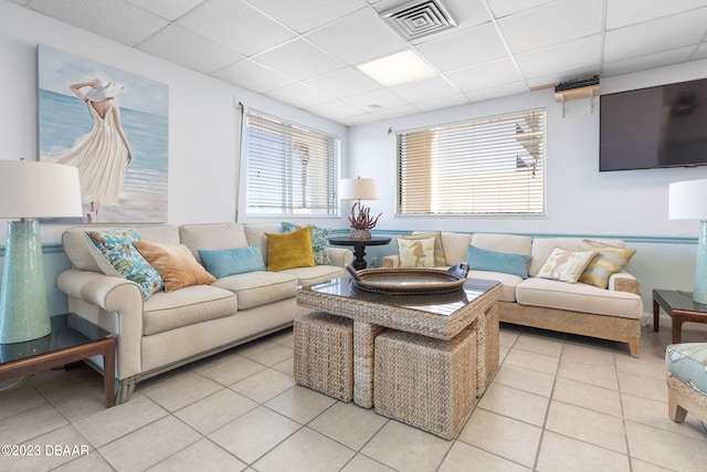 tiled living room with a drop ceiling