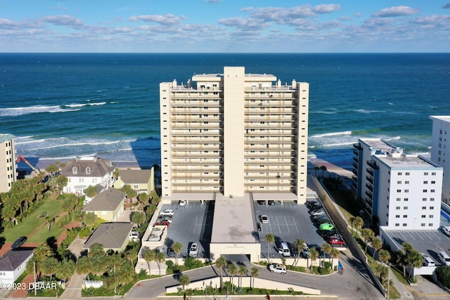 drone / aerial view with a beach view and a water view