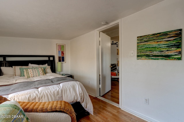 421 N Peninsula Dr, Daytona Beach, FL 32118 - bedroom with light wood-style floors and baseboards