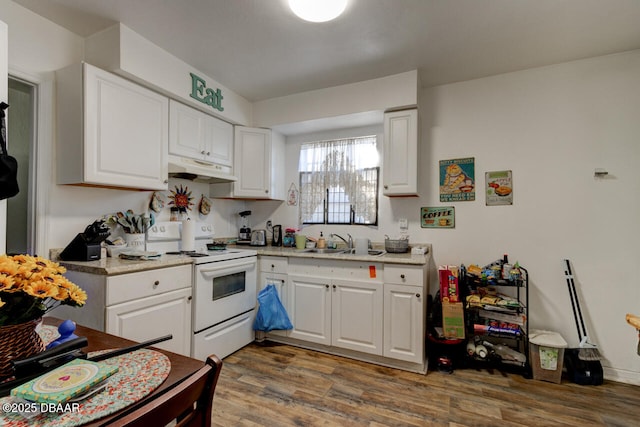 421 N Peninsula Dr, Daytona Beach, FL 32118 - kitchen with white range with electric stovetop, a sink, white cabinets, and wood finished floors