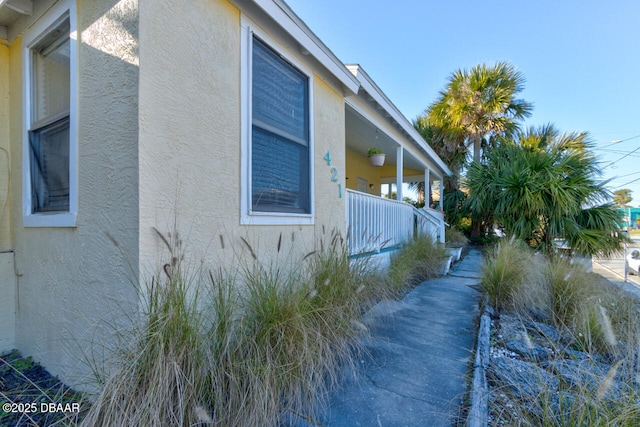 421 N Peninsula Dr, Daytona Beach, FL 32118 - view of property exterior with stucco siding and covered porch