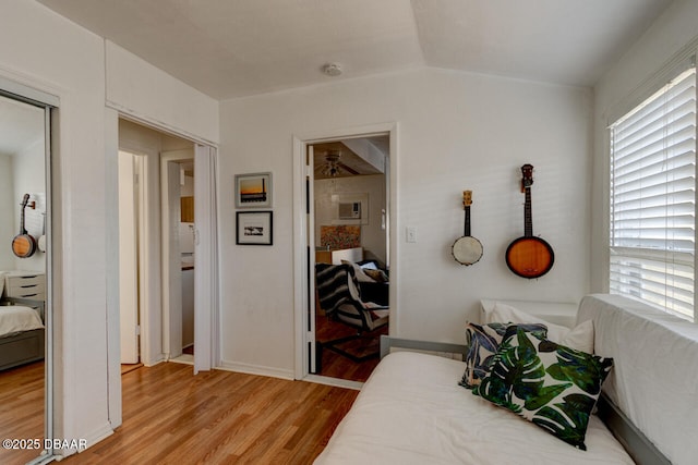 421 N Peninsula Dr, Daytona Beach, FL 32118 - bedroom with light wood-type flooring, multiple windows, and baseboards