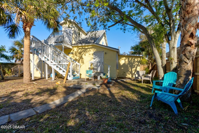 421 N Peninsula Dr, Daytona Beach, FL 32118 - back of property featuring stucco siding and stairway
