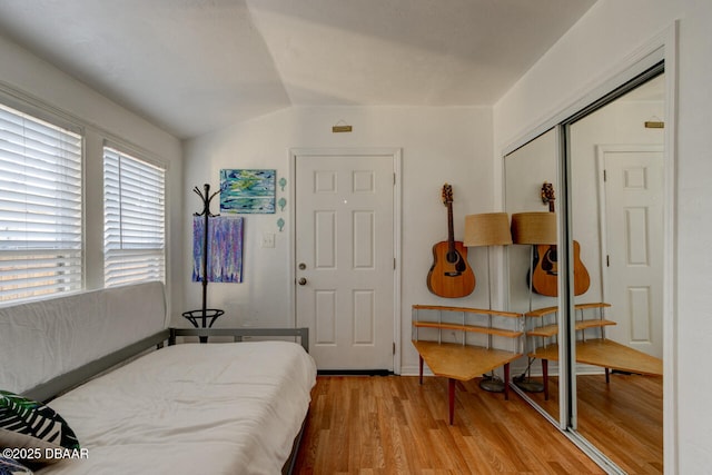 421 N Peninsula Dr, Daytona Beach, FL 32118 - bedroom featuring light wood finished floors, a closet, and lofted ceiling