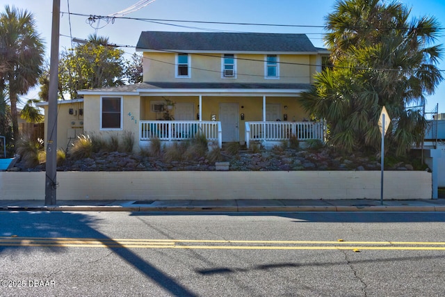 421 N Peninsula Dr, Daytona Beach, FL 32118 - view of front of house featuring stucco siding and a porch