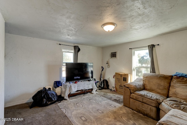 421 N Peninsula Dr, Daytona Beach, FL 32118 - carpeted living room with healthy amount of natural light, a wall unit AC, and baseboards