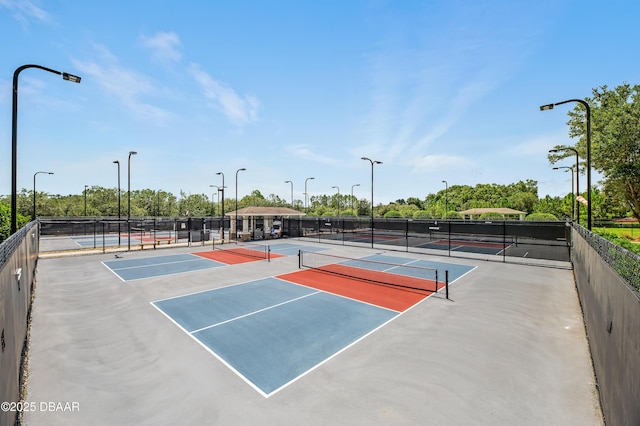 view of tennis court featuring basketball hoop