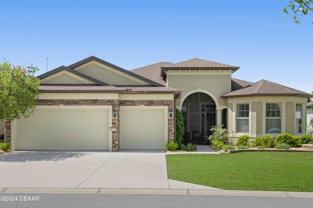 view of front of property featuring a garage and a front lawn