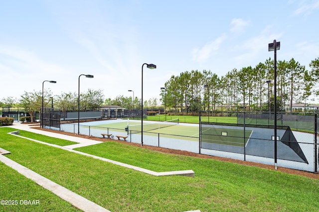 view of tennis court with a lawn