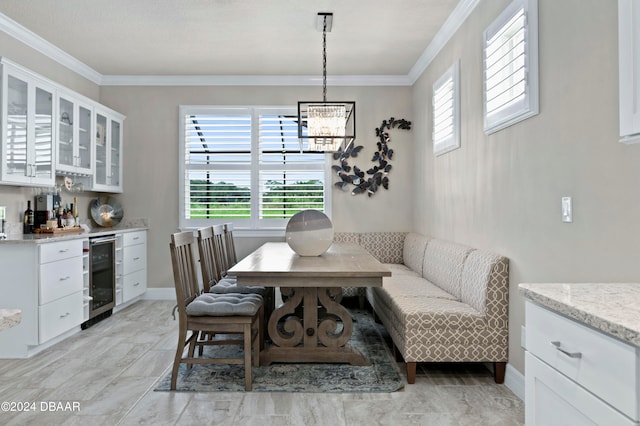 dining area with a chandelier, beverage cooler, and ornamental molding