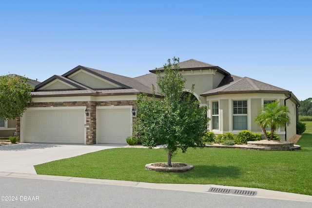 view of front of home featuring a front yard and a garage