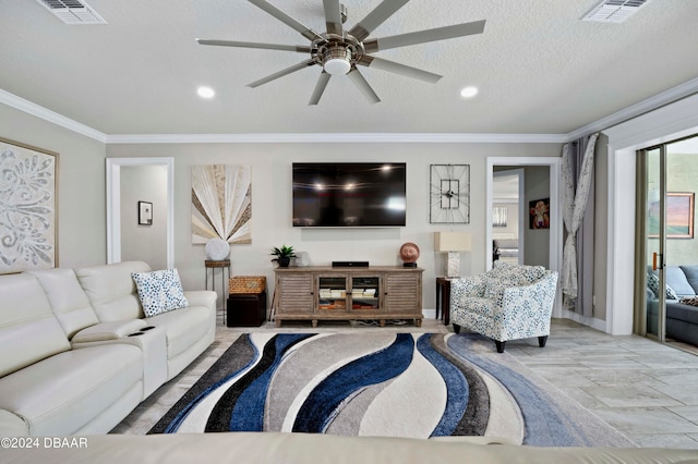 living room featuring ceiling fan, crown molding, and a textured ceiling