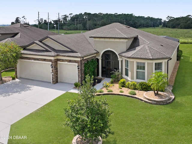 ranch-style house featuring a garage and a front lawn