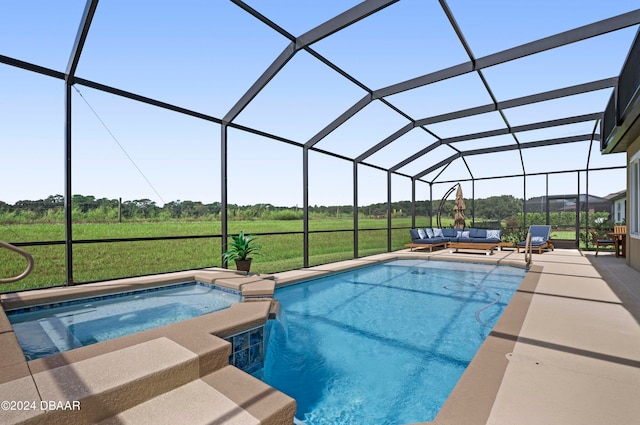 view of swimming pool featuring an in ground hot tub, a lanai, a rural view, a patio area, and a yard