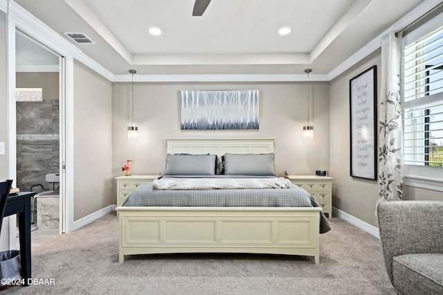 bedroom featuring ceiling fan, a raised ceiling, and light carpet