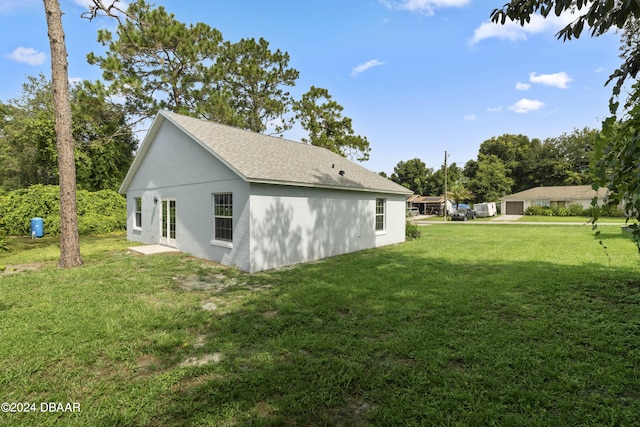 view of side of home with a lawn