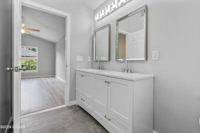 bathroom featuring vanity, vaulted ceiling, ceiling fan, and wood-type flooring