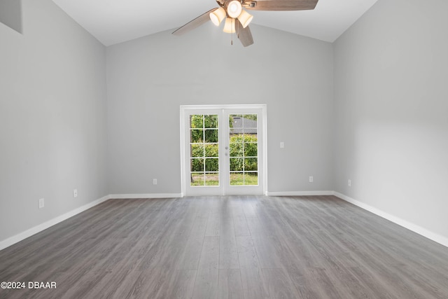 empty room with french doors, hardwood / wood-style floors, ceiling fan, and high vaulted ceiling