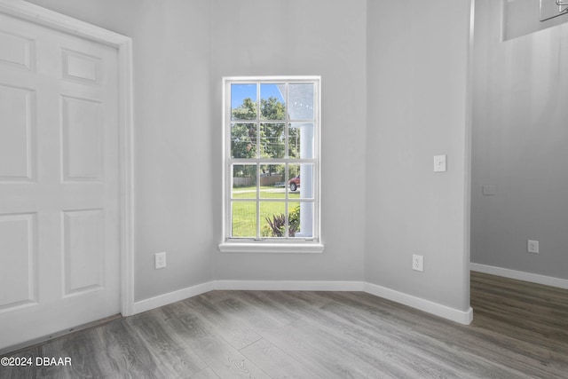 unfurnished room with hardwood / wood-style flooring