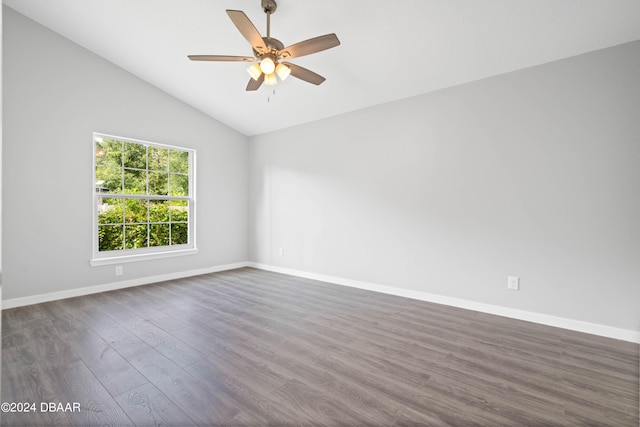 empty room featuring dark hardwood / wood-style floors, ceiling fan, and vaulted ceiling