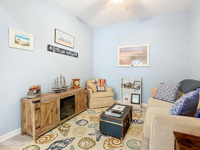 living room with light hardwood / wood-style floors and ceiling fan