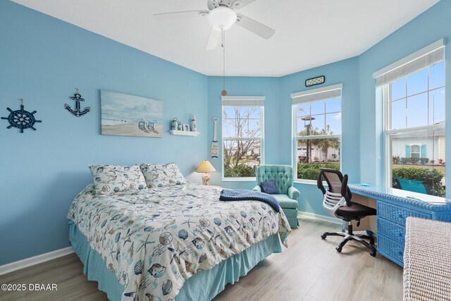 bedroom featuring light hardwood / wood-style floors, ceiling fan, and a closet