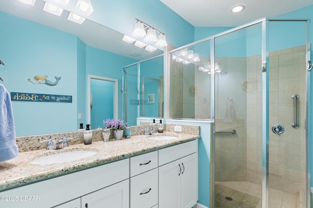 310 Coral Reef Way, Daytona Beach, FL 32124 - full bathroom featuring double vanity, a stall shower, and a sink